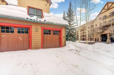 a garage with red doors in the snow at 3 BDR for 10 with Pool & Hot Tub Mins to Ski Lift in Dillon