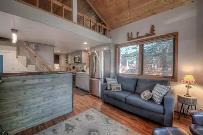 a living room with a couch and a kitchen at Perfect Getaway Cabin with Nearby Hike&Bike Trails in Breckenridge