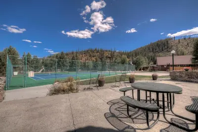 a tennis court with a table and chairs on a tennis court at Perfect Getaway Cabin with Nearby Hike&Bike Trails in Breckenridge
