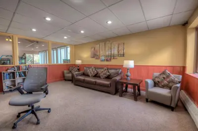 a waiting room with couches and a table and chairs at Perfect Getaway Cabin with Nearby Hike&Bike Trails in Breckenridge