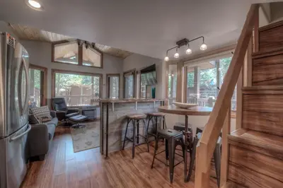a kitchen and living room with a bar in a house at Perfect Getaway Cabin with Nearby Hike&Bike Trails in Breckenridge