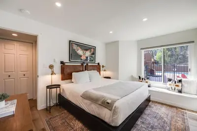 a bedroom with a large bed and a window at Rock Wren Poolside - 3 BDR Condo in Keystone