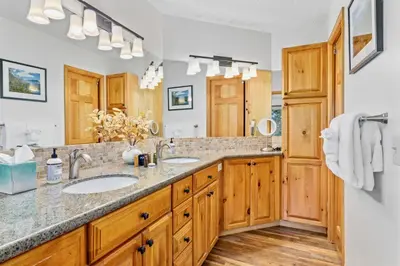 a bathroom with two sinks and a large mirror at Montane Luxury Vacation Rental at Windcliff home in Estes Park