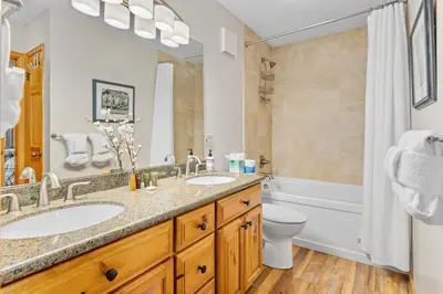 a bathroom with two sinks and a tub and a toilet at Montane Luxury Vacation Rental at Windcliff home in Estes Park