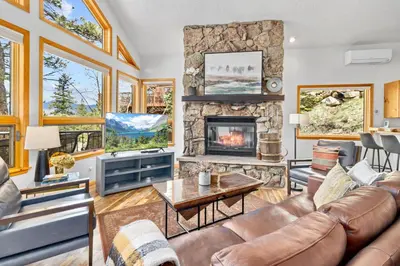 a living room with a couch and a fireplace at Montane Luxury Vacation Rental at Windcliff home in Estes Park