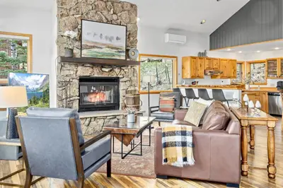 a living room with a couch and a fireplace at Montane Luxury Vacation Rental at Windcliff home in Estes Park