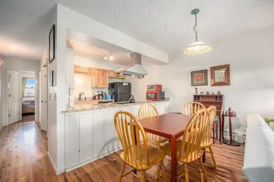 a kitchen and dining room with a table and chairs at Townhouse w hot tub, gym & pool in Fraser