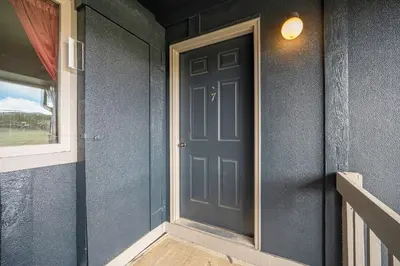 a door on the side of a house at Townhouse w hot tub, gym & pool in Fraser