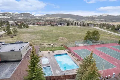 an aerial view of a tennis court and a pool at Townhouse w hot tub, gym & pool in Fraser