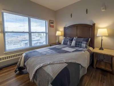 a bedroom with a bed and a large window at Base Camp One 410,0018 in Granby