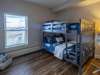 a bedroom with two bunk beds and a window at Base Camp One 410,0018 in Granby