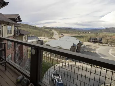 a balcony with a view of a street and a car at Base Camp One 410,0018 in Granby
