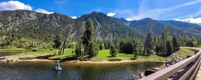 a person is standing on a raft in the water at Base Camp One 410,0018 in Granby