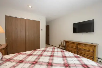 a bedroom with a bed and a tv on the wall at Meadow Ridge Court 31 Unit 4 in Fraser