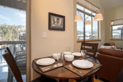 a dining room with a table and a balcony at Trailhead Lodges Building 701 Unit 731 in Winter Park