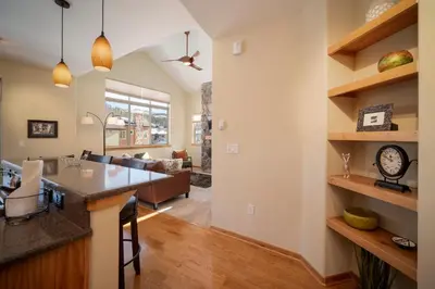 a kitchen and living room of a home with a large island at Trailhead Lodges Building 701 Unit 731 in Winter Park