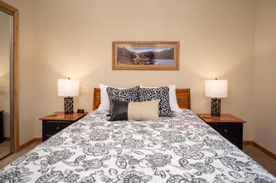 a bedroom with a bed with two lamps on tables at Trailhead Lodges Building 701 Unit 731 in Winter Park