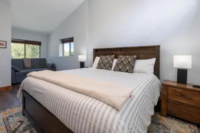 a bedroom with a large bed and a couch at Townhome on Vasquez Creek #8 in Winter Park