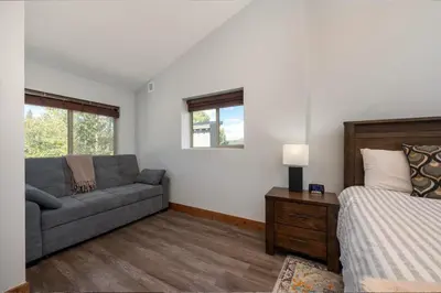 a living room with a couch and a bed at Townhome on Vasquez Creek #8 in Winter Park