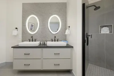 a bathroom with two sinks and two mirrors at Timber Fox Building B Unit 2102 in Winter Park