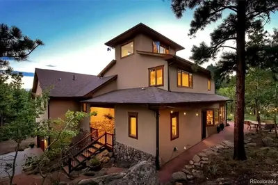a house with a tower on top of it at Luxurious Rocky Mountain Retreat above Boulder in Nederland