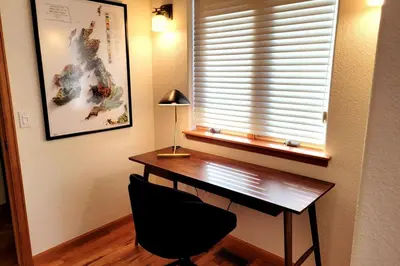 a desk in a room with a window and a chair at Luxurious Rocky Mountain Retreat above Boulder in Nederland
