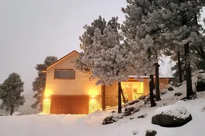 a house with a garage in the snow at Luxurious Rocky Mountain Retreat above Boulder in Nederland