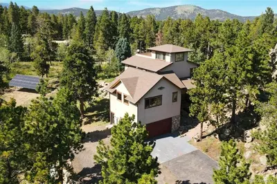 an aerial view of a house in the woods at Luxurious Rocky Mountain Retreat above Boulder in Nederland