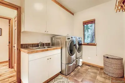 a kitchen with a sink and a dishwasher at Luxurious Rocky Mountain Retreat above Boulder in Nederland