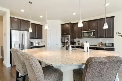 a kitchen with a large marble table and chairs at Spacious Luxury Retreat Near Boulder & Denver in Superior