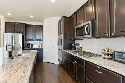 a kitchen with brown cabinets and a counter top at Spacious Luxury Retreat Near Boulder & Denver in Superior
