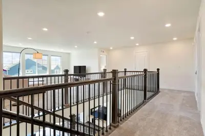 a staircase in a house with a wooden railing at Spacious Luxury Retreat Near Boulder & Denver in Superior
