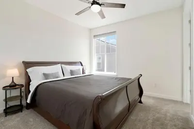 a bedroom with a large bed with a ceiling fan at Spacious Luxury Retreat Near Boulder & Denver in Superior