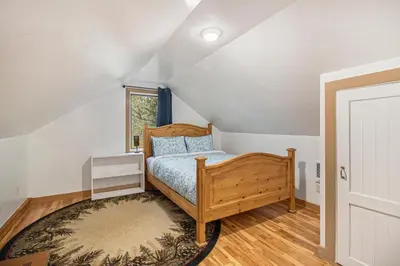 a bedroom with a wooden bed and a window at Cedar Ridge Sanctuary Rocky Mtn Natl Park in Lyons