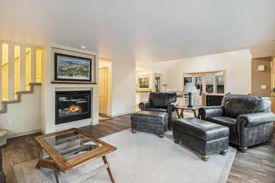 a living room with two chairs and a fireplace at Cedar Ridge Sanctuary Rocky Mtn Natl Park in Lyons