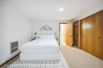 a bedroom with a white bed and wooden cabinets at Pet-Friendly 3 Bedroom Townhome In Frisco - Short Drive To Breck! in Frisco