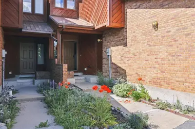 a brick house with flowers in front of it at Pet-Friendly 3 Bedroom Townhome In Frisco - Short Drive To Breck! in Frisco