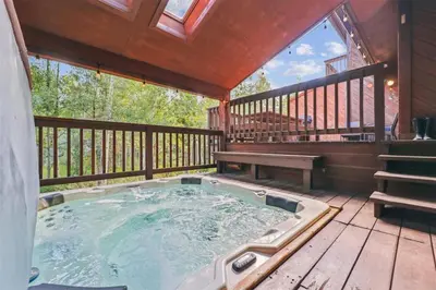 a hot tub on the deck of a cabin at Pet-Friendly 3 Bedroom Townhome In Frisco - Short Drive To Breck! in Frisco