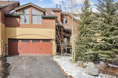a house with a red garage in the driveway at Pet-Friendly 4 Bedroom Townhome In Frisco - Short Drive To Breck! in Frisco