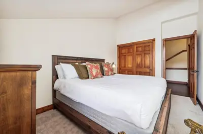 a bedroom with a large bed and a wooden cabinet at Pet-Friendly 4 Bedroom Townhome In Frisco - Short Drive To Breck! in Frisco