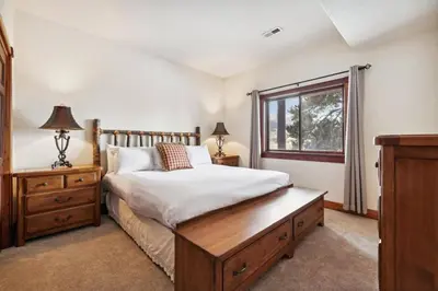 a bedroom with a wooden bed and a window at Pet-Friendly 4 Bedroom Townhome In Frisco - Short Drive To Breck! in Frisco