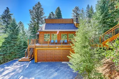 a cabin in the woods with a garage at Evergreen Forest Retreat in Evergreen