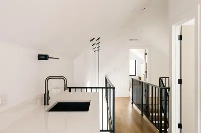 a kitchen with white walls and a sink in a room at New Modern Luxe Stay - Roof Deck - Center of RiNo in Denver