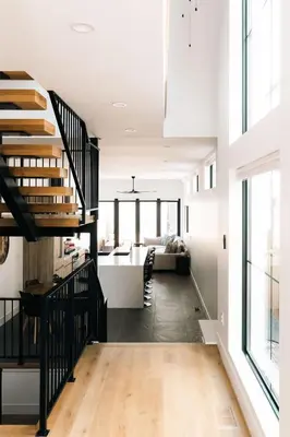 a living room with a staircase and a dining room at New Modern Luxe Stay - Roof Deck - Center of RiNo in Denver
