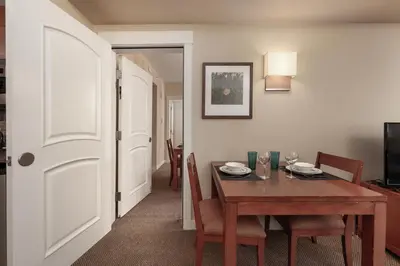 a dining room with a wooden table and chairs at Founders Pointe 4471 Ski In Ski Out Winter Park Resort in Winter Park