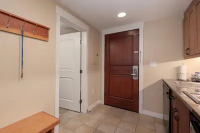 a kitchen with a wooden door and a counter top at Founders Pointe 4471 Ski In Ski Out Winter Park Resort in Winter Park