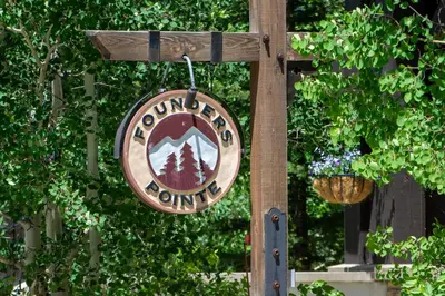 a sign for a forest outlet hanging from a pole at Founders Pointe 4471 Ski In Ski Out Winter Park Resort in Winter Park
