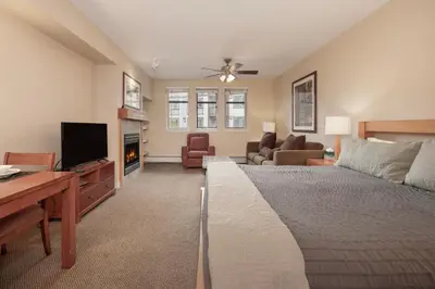 a bedroom with a bed and a living room at Founders Pointe 4471 Ski In Ski Out Winter Park Resort in Winter Park