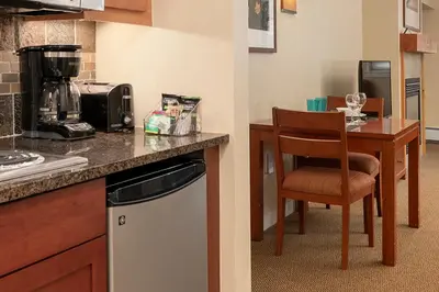 a kitchen with a counter and a chair and a table at Founders Pointe 4471 Ski In Ski Out Winter Park Resort in Winter Park