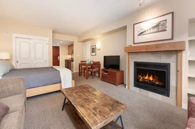 a hotel room with a bed and a fireplace at Founders Pointe 4471 Ski In Ski Out Winter Park Resort in Winter Park